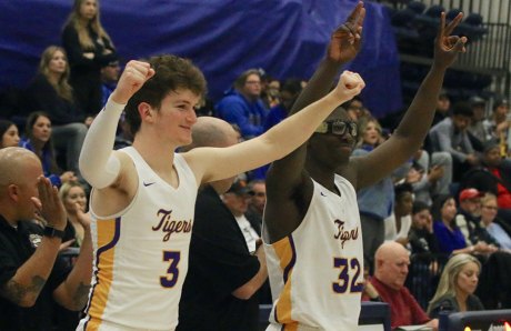 Lemoore's Will Schalde and Daniel Charleston celebrate as the Tigers defeat Hanford West in the Central Section Division 2 playoff game Friday night in Lemoore.